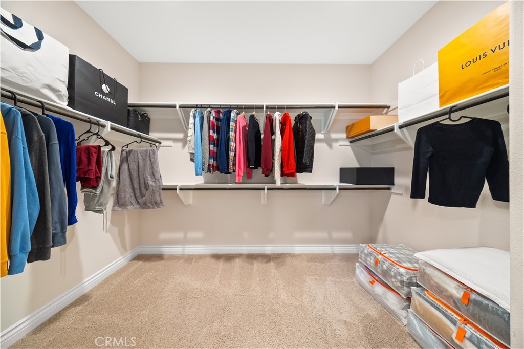 111 Lovelace Irvine, CA 92620 - Photo 36 of 55 a view of walk in closet with clothes and shoes