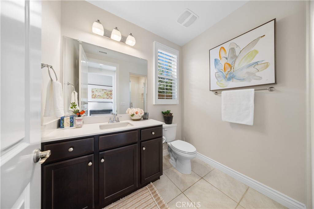 111 Lovelace Irvine, CA 92620 - Photo 37 of 55 a bathroom with a toilet a sink a mirror and a window