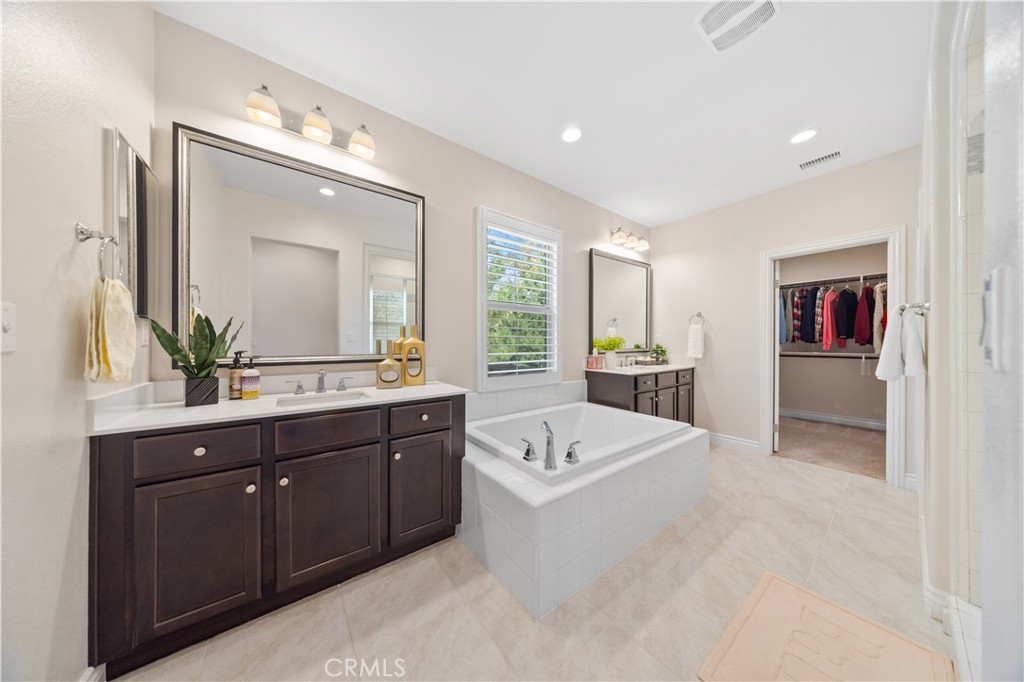 111 Lovelace Irvine, CA 92620 - Photo 38 of 55 a spacious bathroom with a tub double sink and mirror