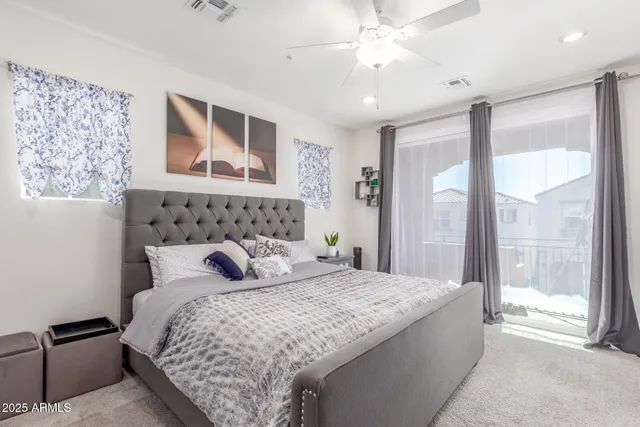 a bedroom with a large bed and a chandelier