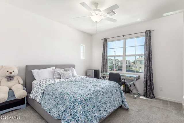 a bedroom with a bed and a window