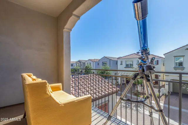 a view of a patio with couches chairs under an umbrella