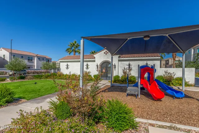 a view of a house with a backyard and a patio