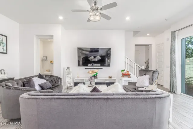 a living room with furniture and a large window