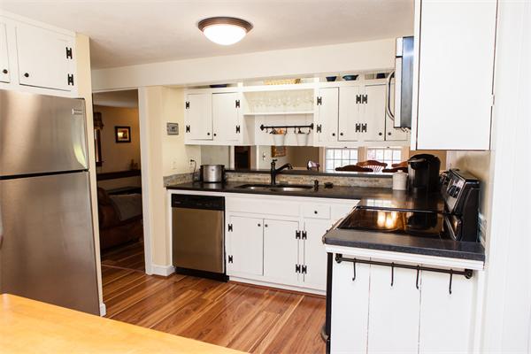 33 Laurel Road Bolton, MA 01740 - Photo 13 of 30 a kitchen with a refrigerator and a stove top oven