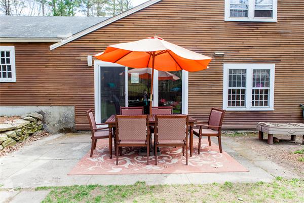 33 Laurel Road Bolton, MA 01740 - Photo 24 of 30 a view of a house with backyard and sitting area