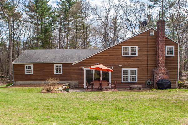 33 Laurel Road Bolton, MA 01740 - Photo 27 of 30 a backyard of a house with barbeque oven