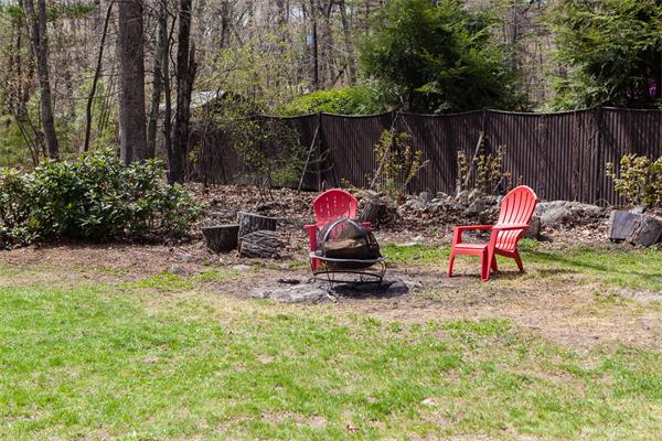 33 Laurel Road Bolton, MA 01740 - Photo 29 of 30 a backyard of a house with table and chairs