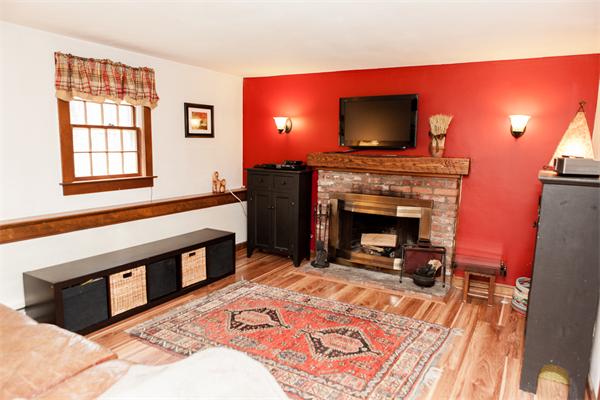 33 Laurel Road Bolton, MA 01740 - Photo 10 of 30 a living room with furniture a flat screen tv and a fireplace