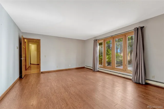 a view of an empty room with glass door and balcony