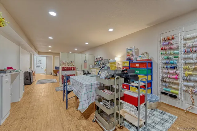 a playing room with furniture and a wooden floor