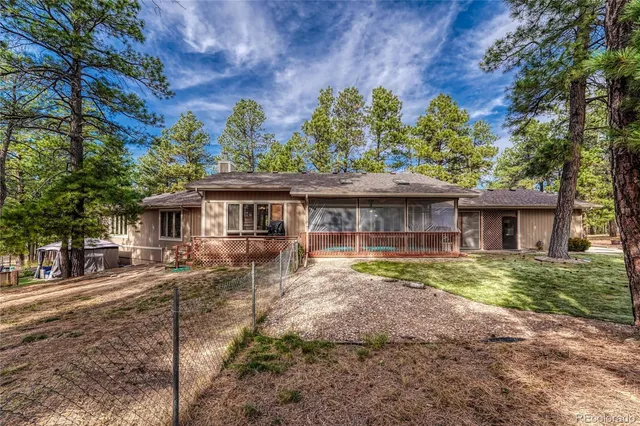 a front view of house with a garden