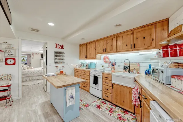 a kitchen with a sink stove and cabinets