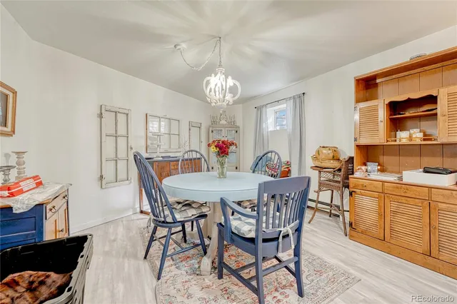 a view of a dining room with furniture and chandelier