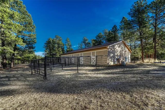 a view of back yard with wooden fence
