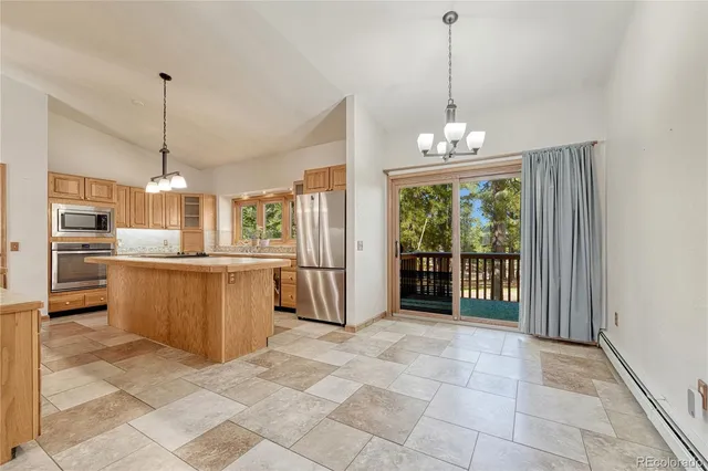 a view of a kitchen with refrigerator and microwave