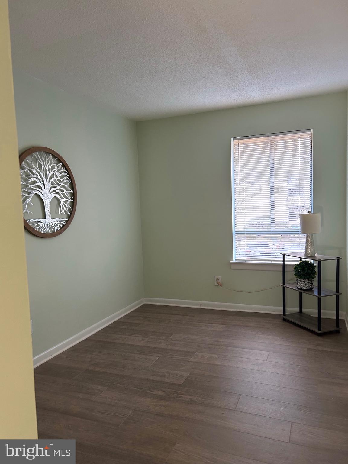 11609 Stoneview Square, Unit 11C Reston, VA 20191 - Photo 11 of 23 a room with a window and wooden floor