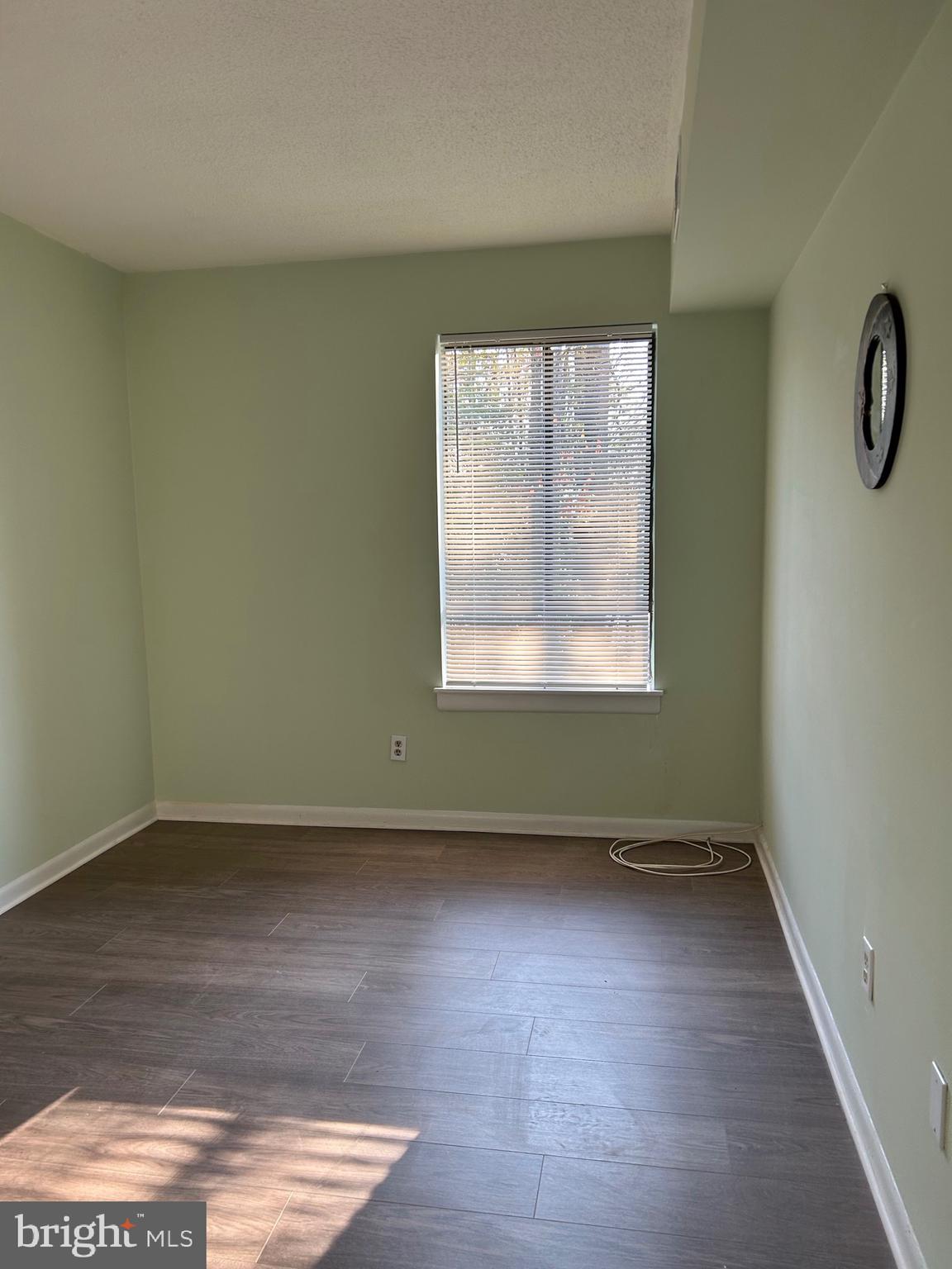 11609 Stoneview Square, Unit 11C Reston, VA 20191 - Photo 12 of 23 an empty room with wooden floor and windows