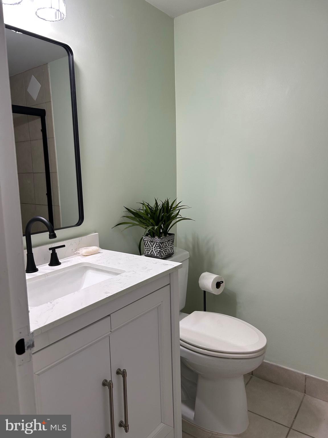 11609 Stoneview Square, Unit 11C Reston, VA 20191 - Photo 14 of 23 a bathroom with a toilet sink and mirror