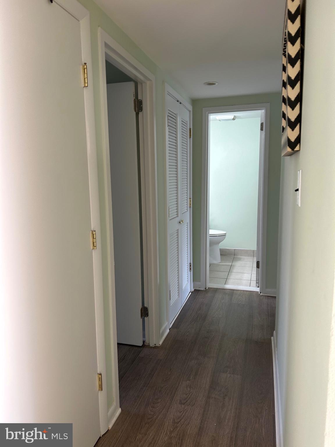 11609 Stoneview Square, Unit 11C Reston, VA 20191 - Photo 17 of 23 a view of a hallway with wooden floor and a bathroom