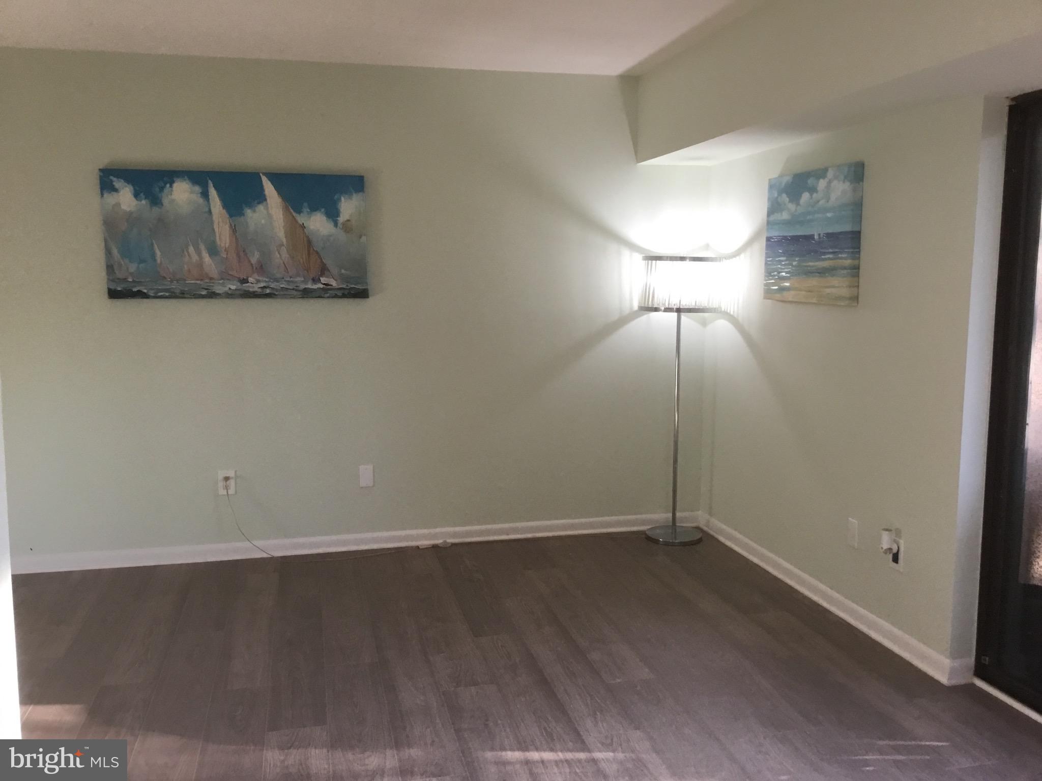 11609 Stoneview Square, Unit 11C Reston, VA 20191 - Photo 22 of 23 an empty room with wooden floor and window