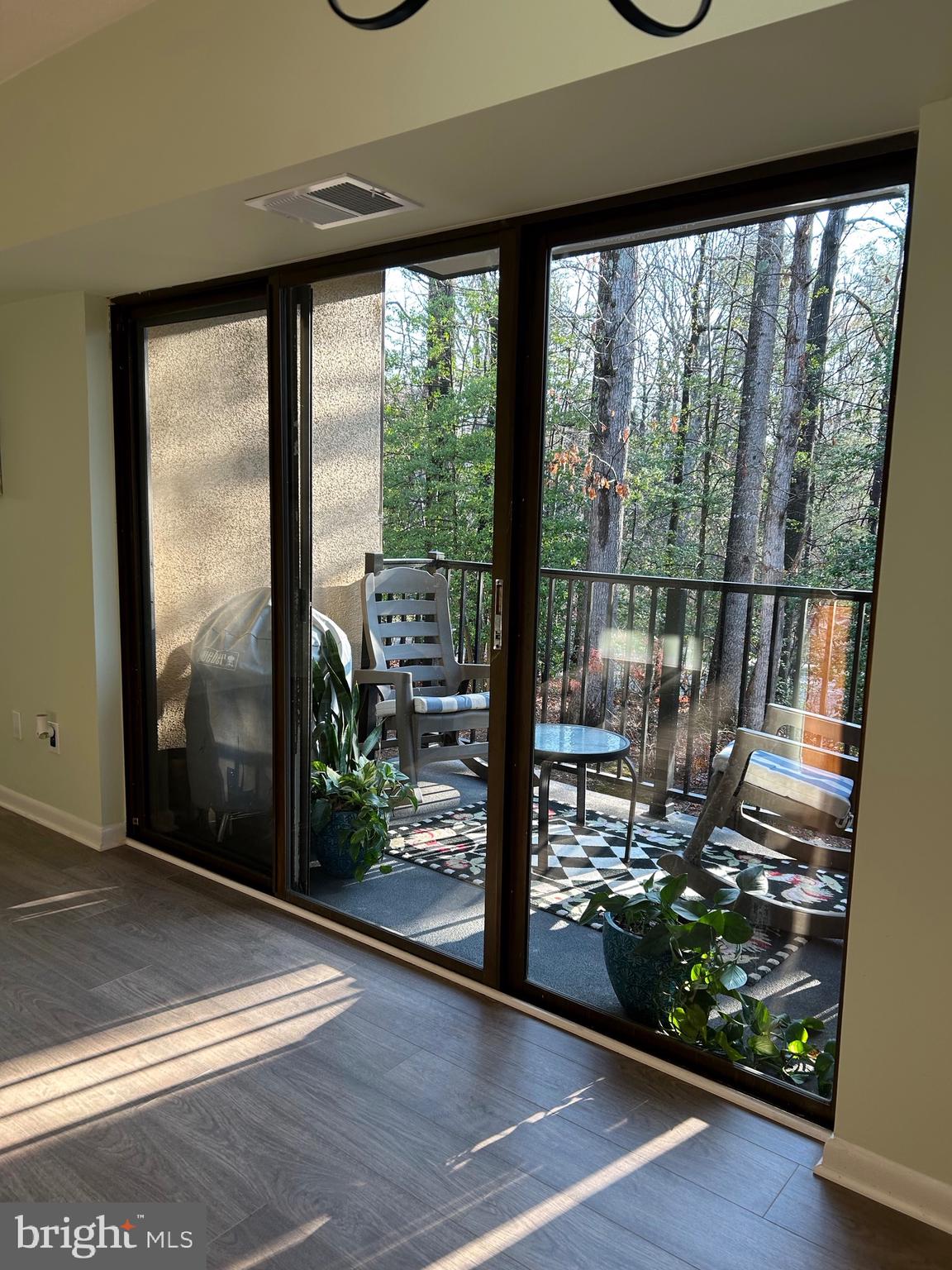 11609 Stoneview Square, Unit 11C Reston, VA 20191 - Photo 7 of 23 a view of a living room and floor to ceiling window