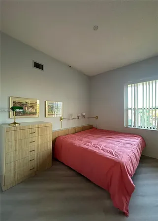 a bedroom with a bed and a cabinets