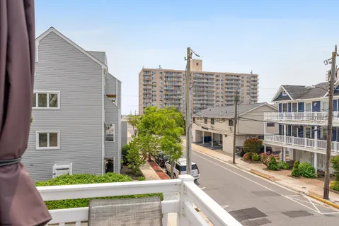 a front view of a building with plants