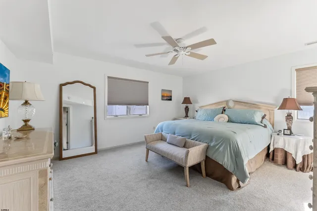 a spacious bedroom with a bed and a chandelier