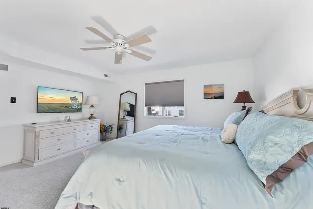 a bedroom with a bed and a dresser