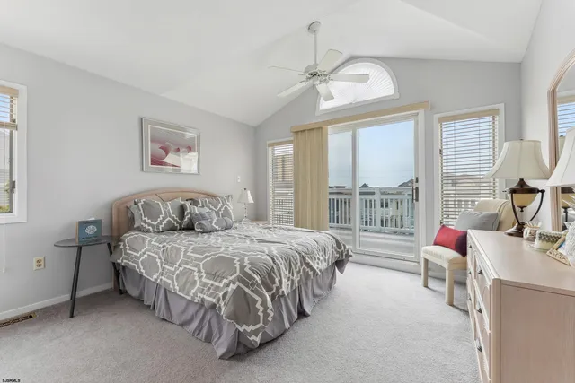 a spacious bedroom with a bed and a chandelier