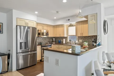 a kitchen with stainless steel appliances granite countertop a refrigerator and a sink