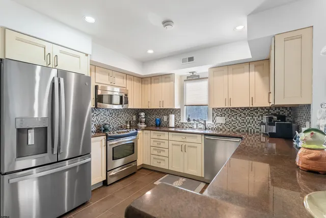 a kitchen with granite countertop stainless steel appliances and wooden cabinets