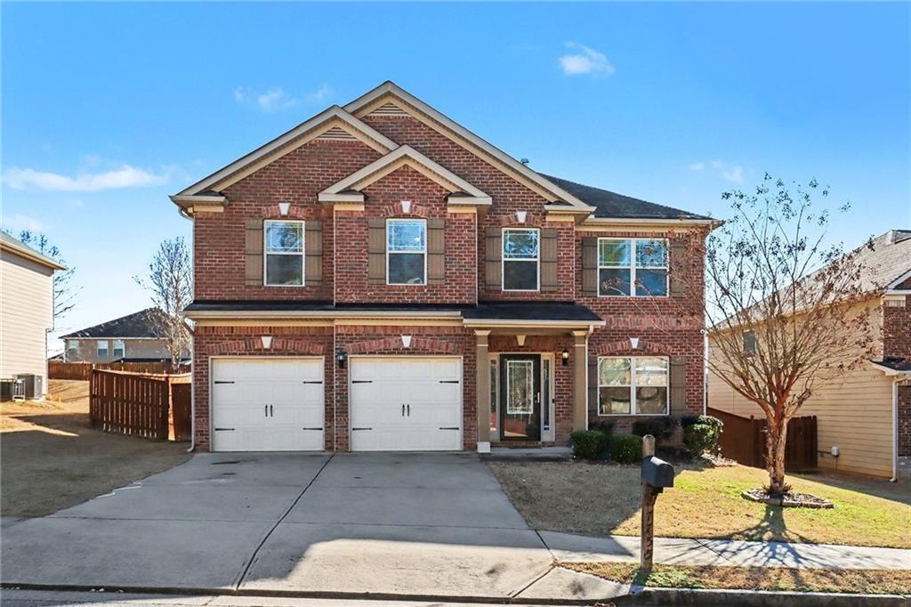 7755 Wrotham Circle Atlanta, GA 30349 - Photo 1 of 1 a front view of a house with a yard