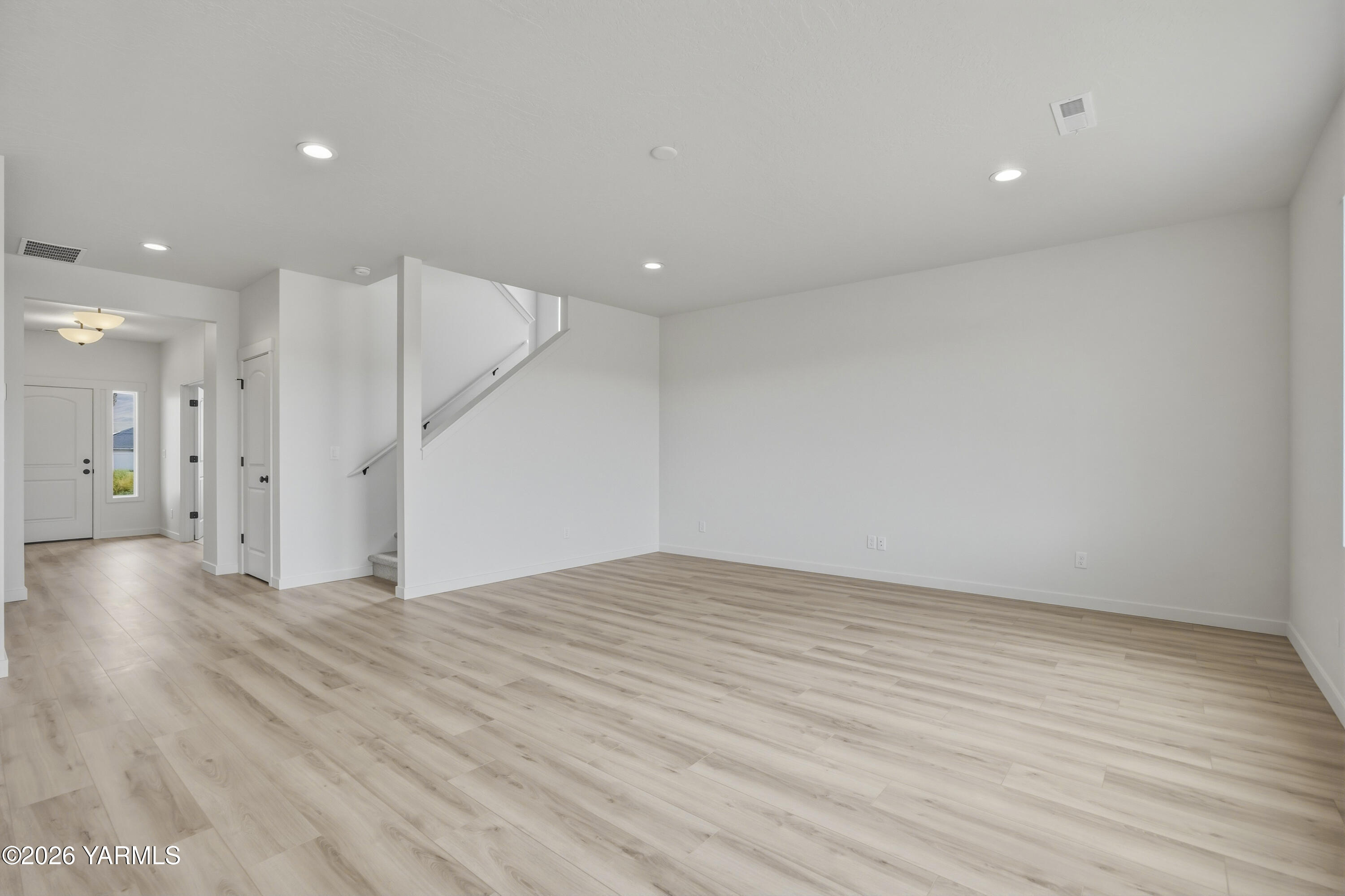 215 Packer Street Prosser, WA 99350 - Photo 37 of 45 a view of an empty room with wooden floor and a ceiling fan
