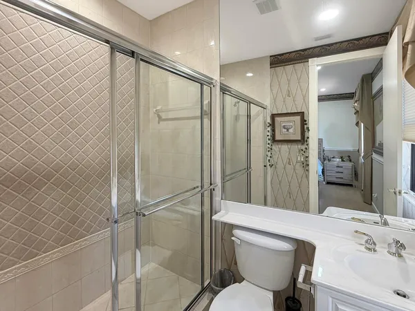 a bathroom with a granite countertop sink toilet and shower
