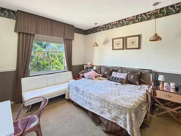 a bedroom with a bed and a painting on the wall