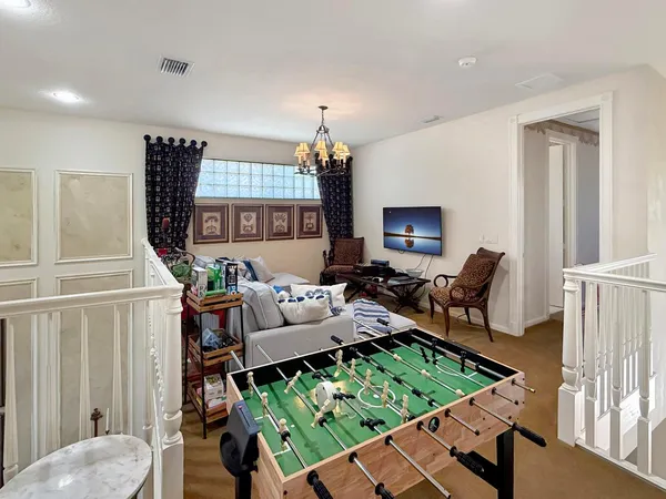 a living room with furniture and a chandelier