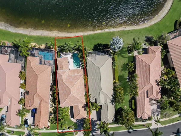 an aerial view of a house with outdoor space and lake view