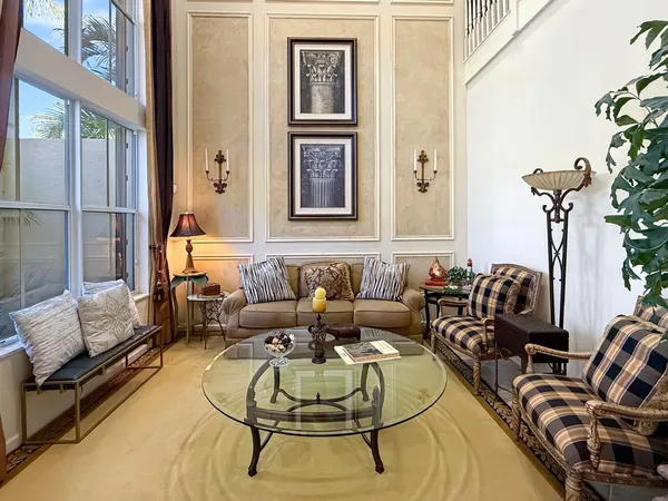 a living room with furniture and a potted plant