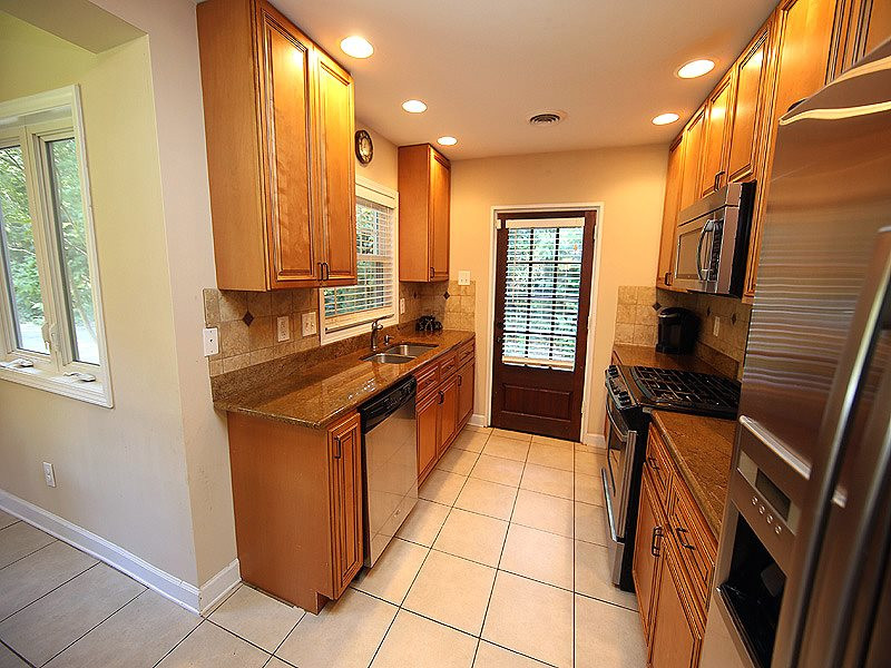 1315 Chaney Road Raleigh, NC 27606 - Photo 9 of 25 Unloading your groceries is a breeze with this side kitchen door. The driveway goes all the way up for easy access! Kitchen