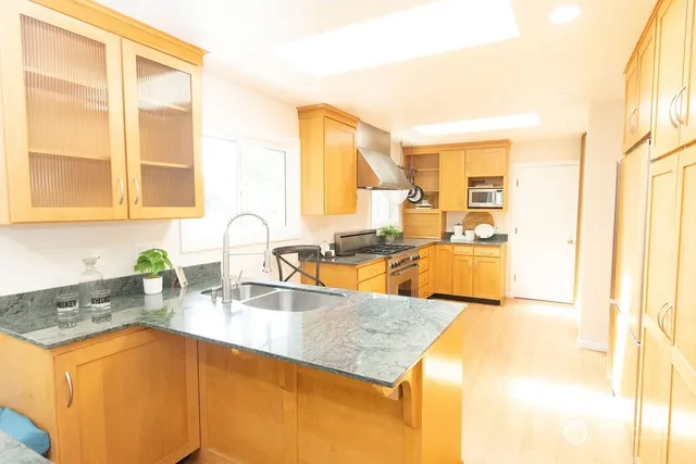 a kitchen with sink refrigerator and cabinets