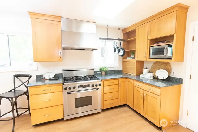 a kitchen with a stove a sink and a refrigerator