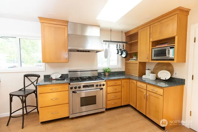 a kitchen with a stove a sink and a refrigerator