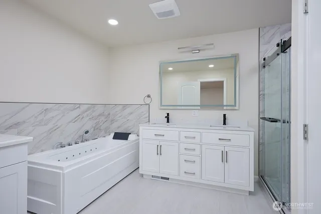 a bathroom with a sink vanity and mirror