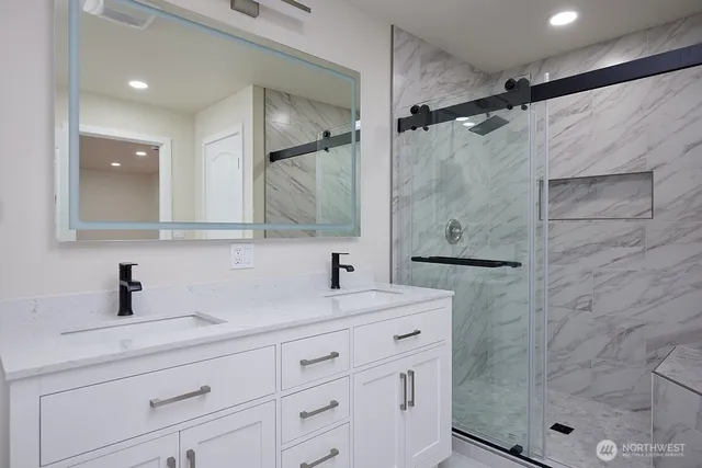 a bathroom with a shower sink and mirror