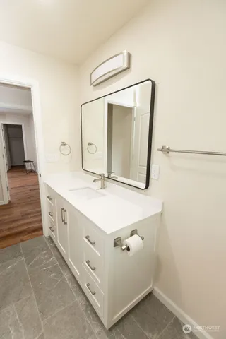 a bathroom with a double vanity sink and a mirror