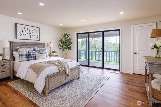 a bedroom with a large bed and a large window