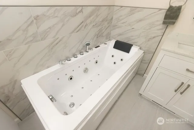 a white bath tub sitting in a bathroom