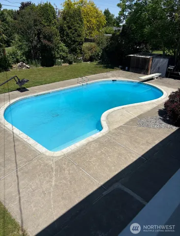 a view of a swimming pool with a yard